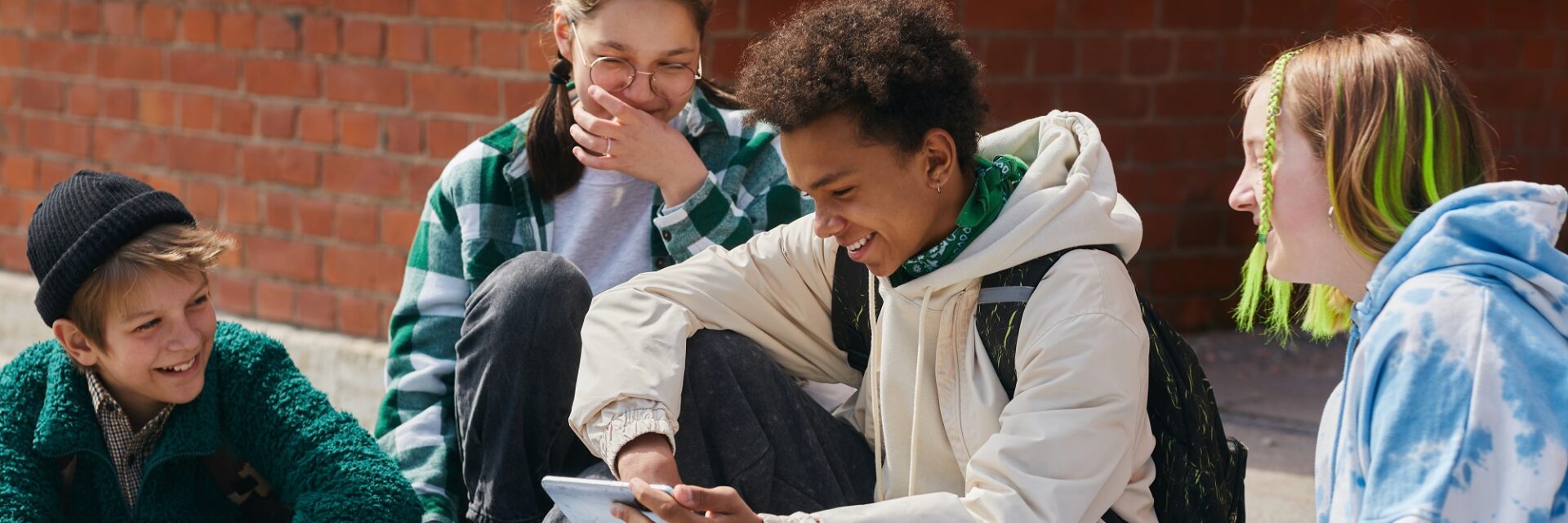 Group of friends sitting together using their phones